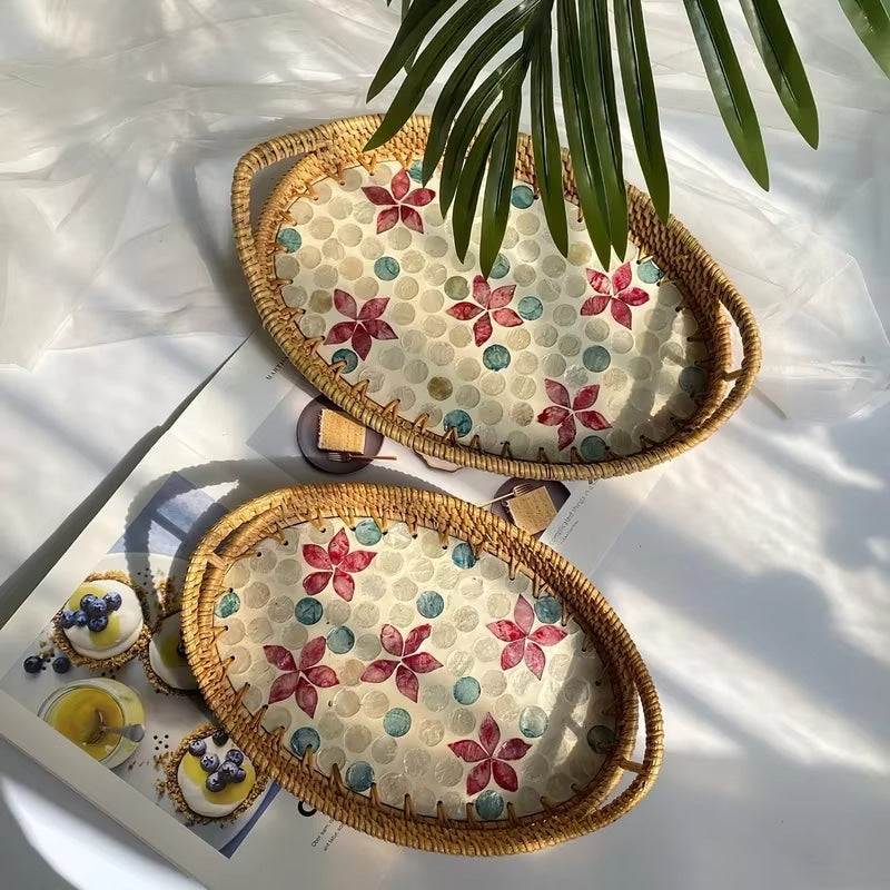 Oval rattan tray with red floral pattern and woven border