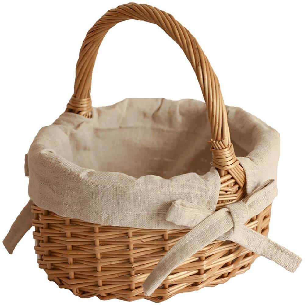 Oval wicker basket with beige linen liner tied with a bow