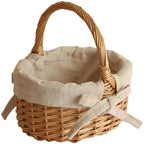 Oval wicker basket with beige linen liner tied with a bow