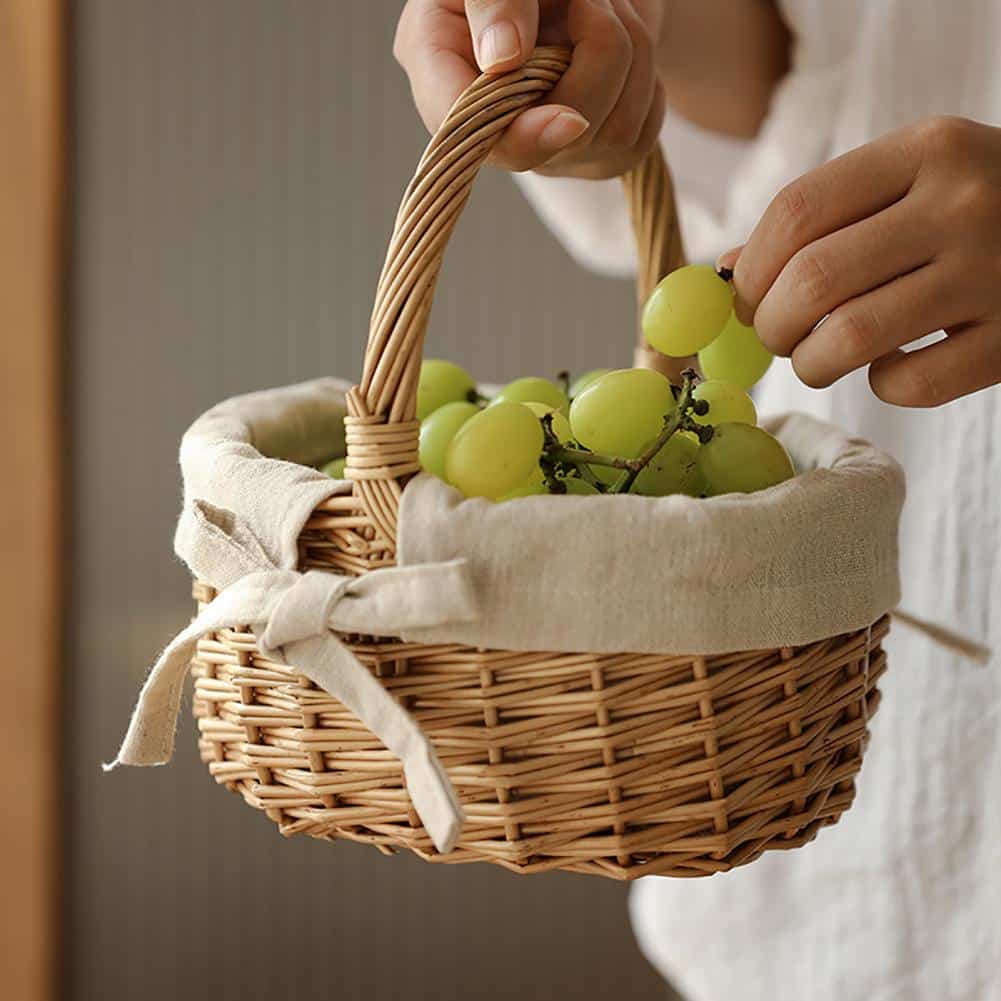 Oval wicker basket with beige linen liner tied with a bow