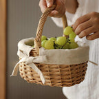 Oval wicker basket with beige linen liner tied with a bow