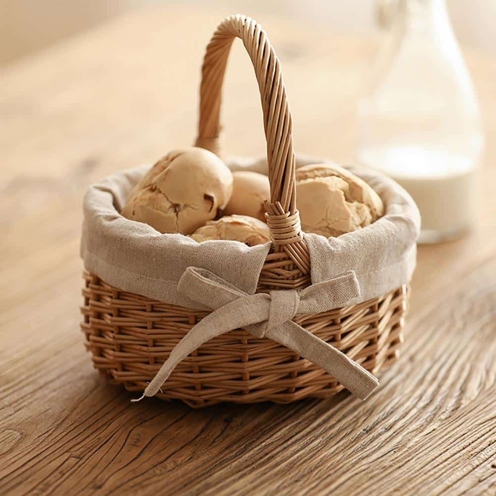 Oval wicker basket with beige linen liner tied with a bow
