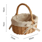 Oval wicker basket with beige linen liner tied with a bow