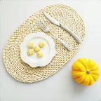Oval placemat hand woven in golden dried corn husk