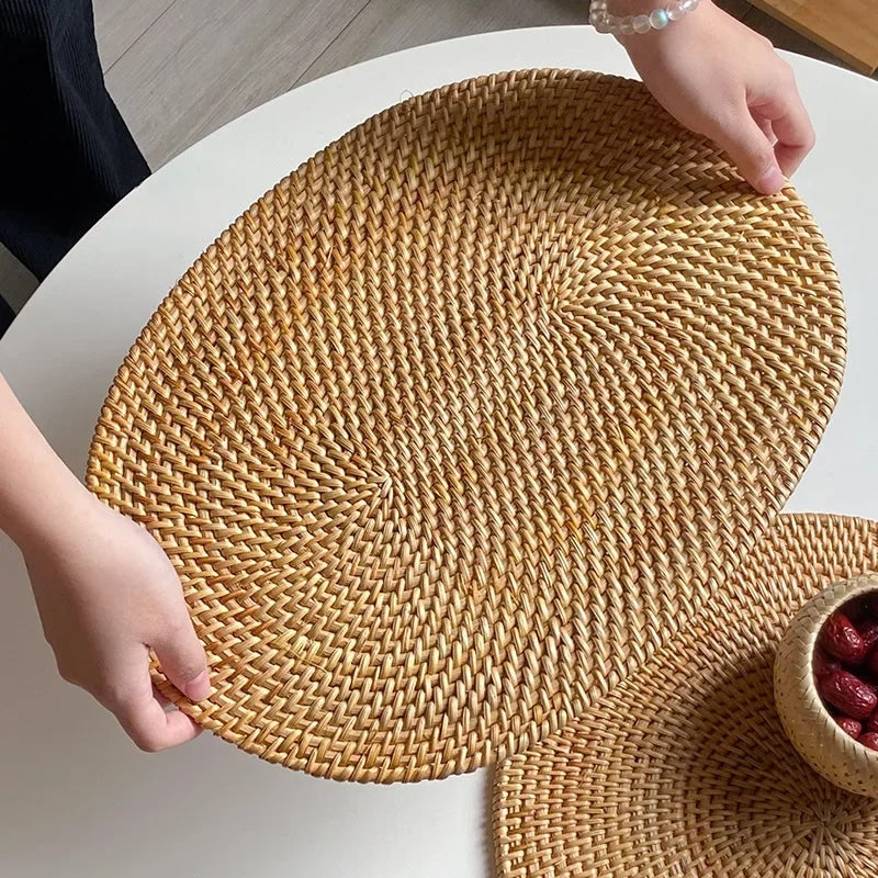 Large oval hand woven rattan serving mat under a glass casserole