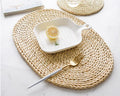 Large oval hand woven rattan trivet under a baking dish