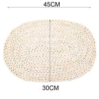 Large oval hand woven rattan trivet under a baking dish