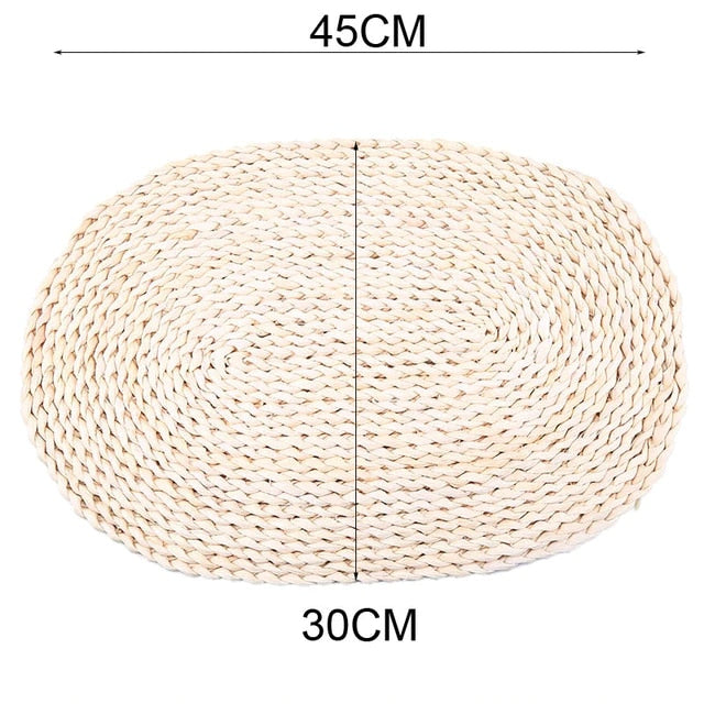Large oval hand woven rattan trivet under a baking dish
