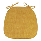 Yellow padded polyester seat cushion with ties for a rattan chair