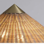 Rattan floor lamp with a wide woven hat shaped shade and a round gold base