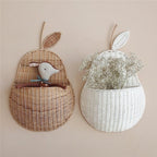 Pear shaped rattan wall baskets in brown and white with plush toys