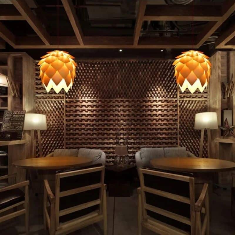 Pine cone shaped pendant light made of layered natural wood scales