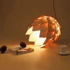 Pine cone shaped pendant light made of layered natural wood scales