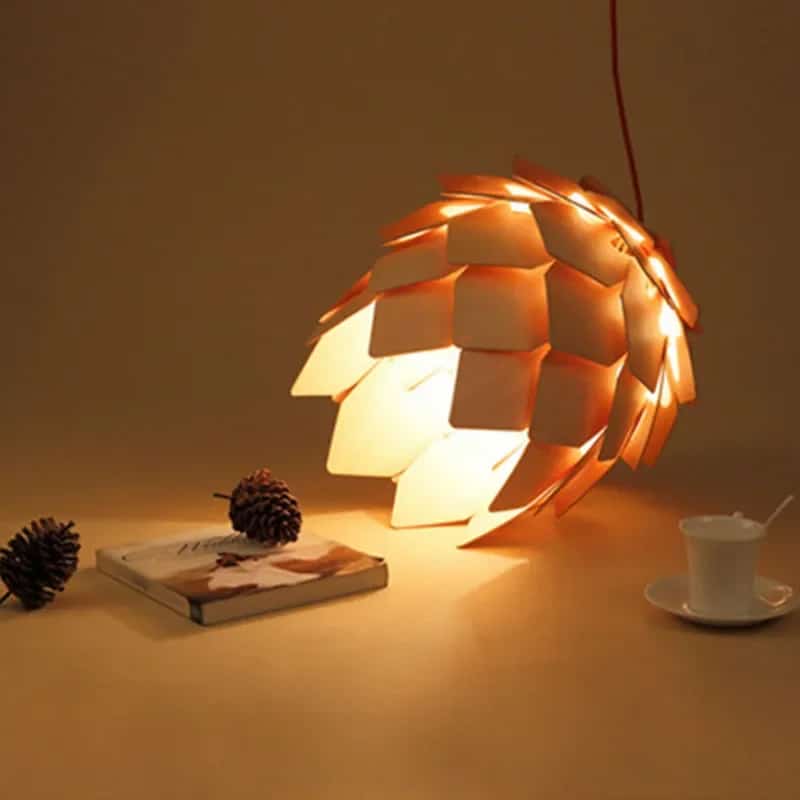 Pine cone shaped pendant light made of layered natural wood scales