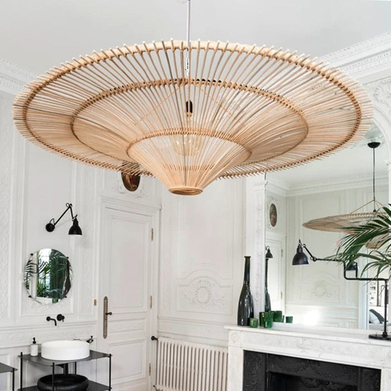 Large saucer pendant of radiating rattan strands in a white room
