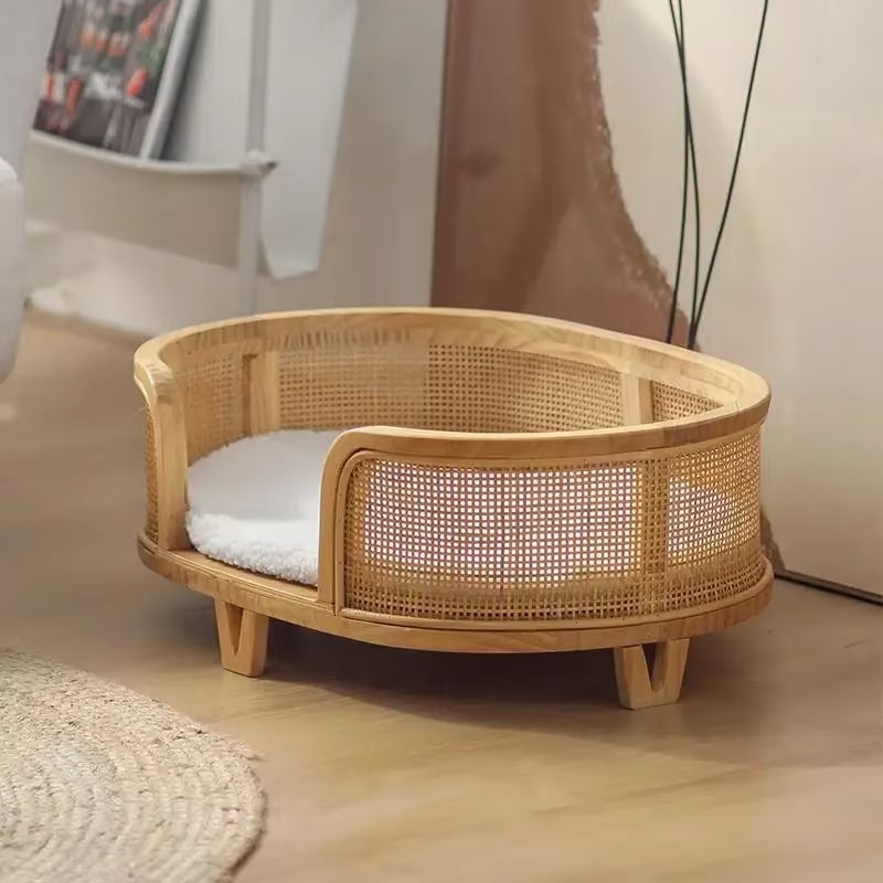 Raised wicker dog bed with tapered legs and cushion