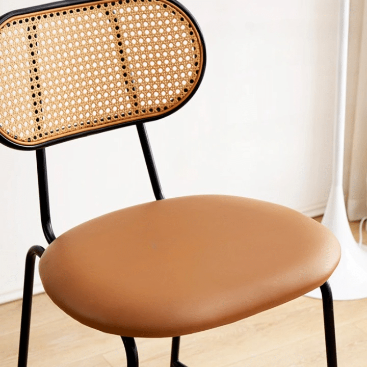 Hand woven rattan bar stool with a back and an embossed leather seat