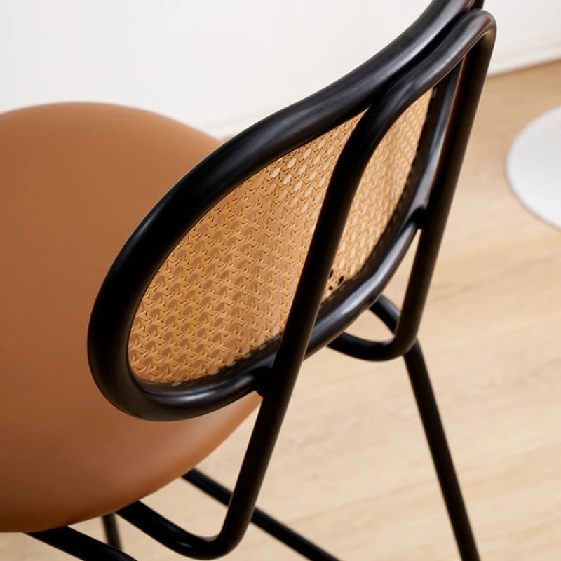 Hand woven rattan bar stool with a back and an embossed leather seat