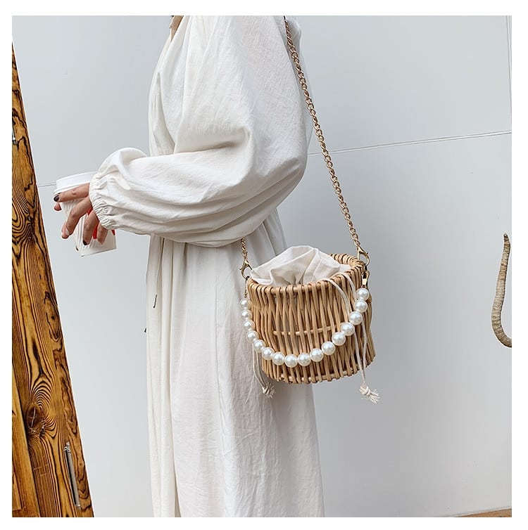 Small round rattan bucket bag with pearl handle
