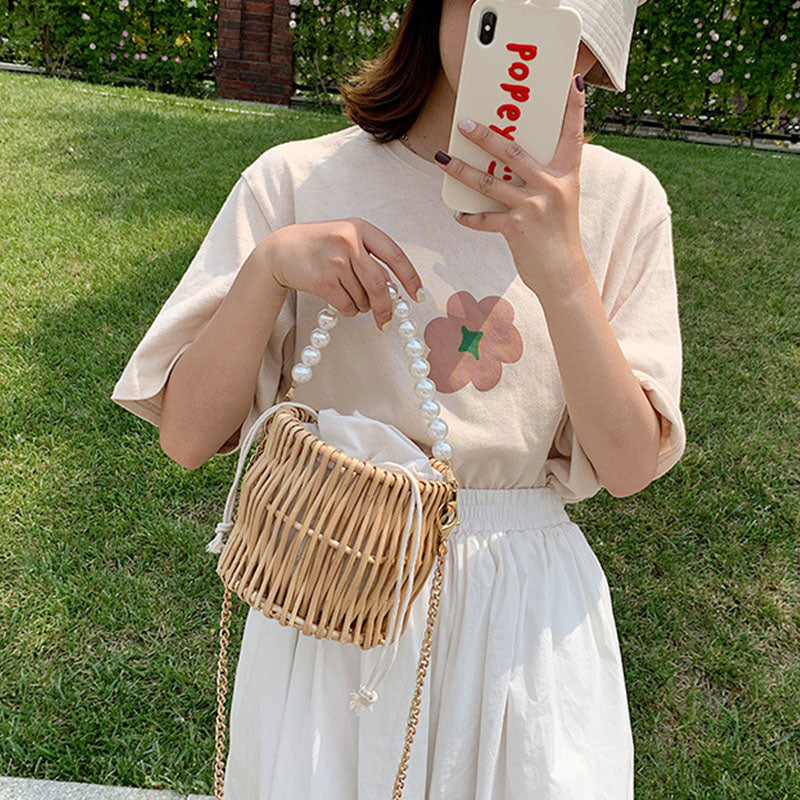 Small round rattan bucket bag with pearl handle