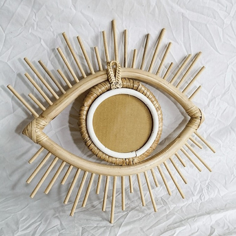 Eye shaped rattan mirrors with sunburst rays