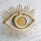 Eye shaped rattan mirrors with sunburst rays
