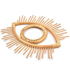 Open rattan eye shaped wall frame with rays