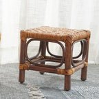 Square footstool with a hand woven rattan top on a dark wood frame