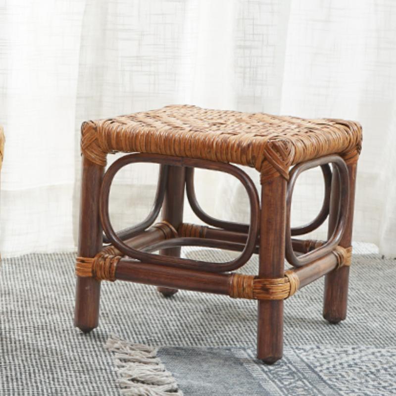 Square footstool with a hand woven rattan top on a dark wood frame