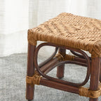 Square footstool with a hand woven rattan top on a dark wood frame