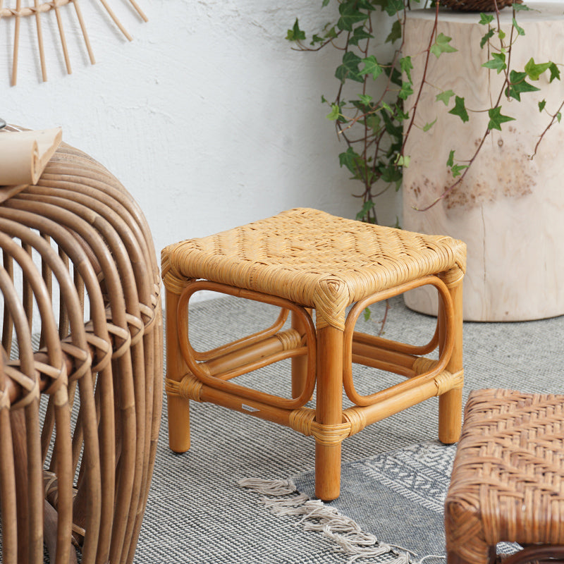 Square footstool with a hand woven rattan top on a light wood frame