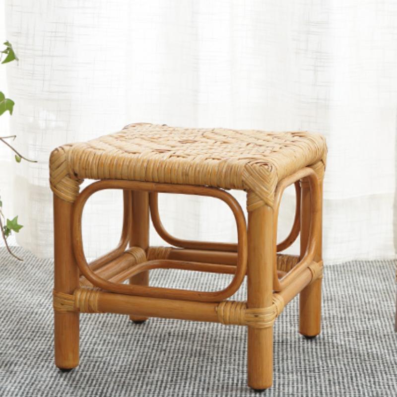 Square footstool with a hand woven rattan top on a light wood frame