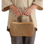 Honey toned hand woven rattan handbag with varnished wooden handles and a drawstring