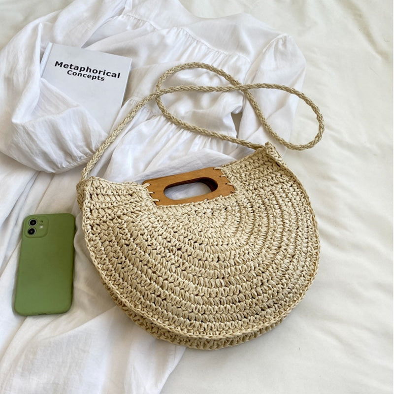 Rounded hand woven rattan handbag with a natural wooden handle