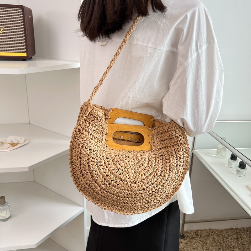 Rounded hand woven rattan handbag with a natural wooden handle