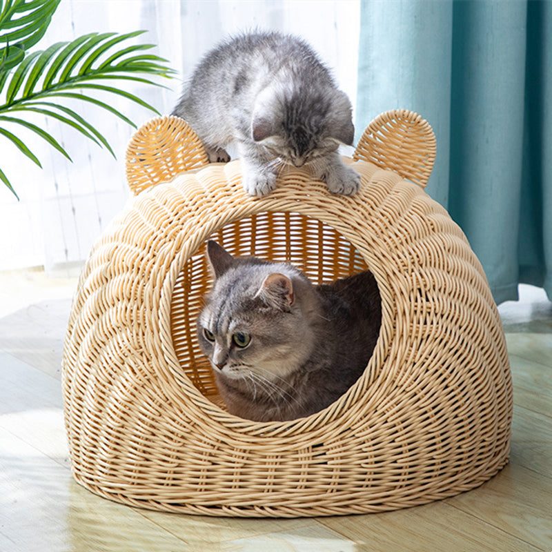 Beige cat bed in molded plastic with a woven rattan look