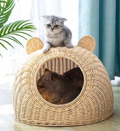 Beige cat bed in molded plastic with a woven rattan look