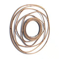 Round mirror framed by overlapping rattan rings