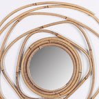 Round mirror framed by overlapping rattan rings