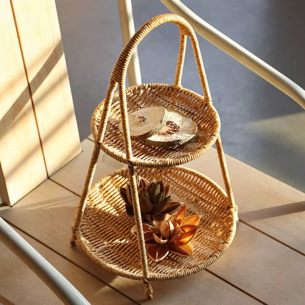 Rattan tiered basket stand with a carrying handle on a patio table