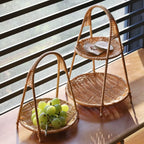 Rattan tiered basket stand with a carrying handle on a patio table