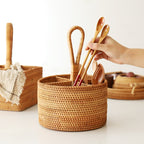Round and square rattan utensil holders with wooden spoons