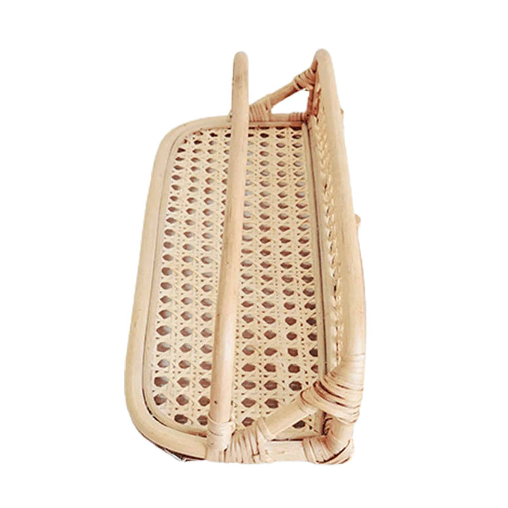 Hand woven rattan wall rack with metal coat hooks in a warm beige