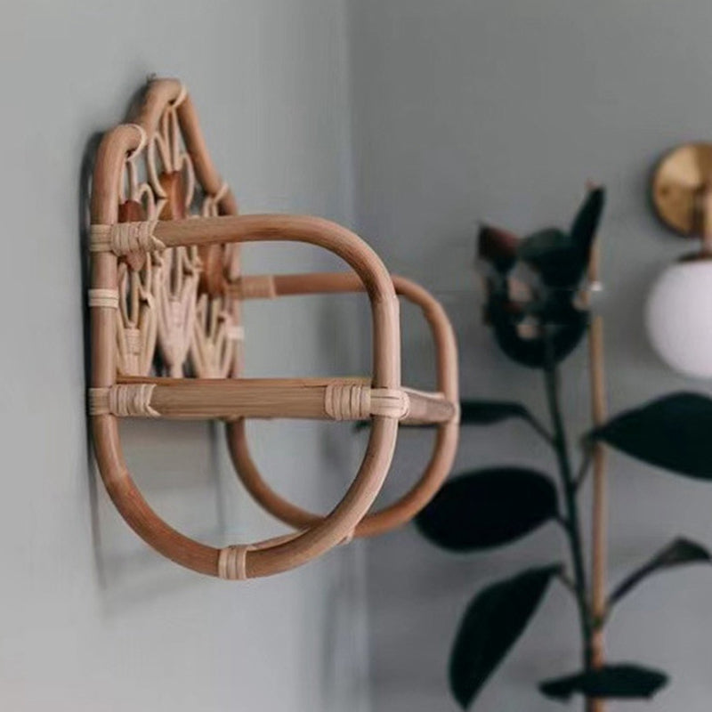 Natural rattan wall coat rack with a hanging rail and a hand woven floral top shelf