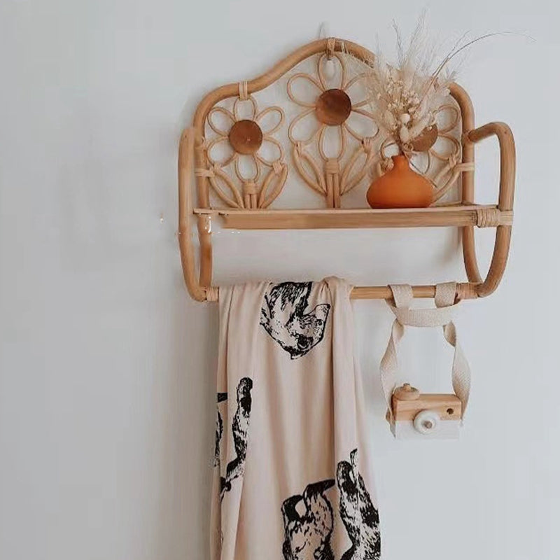 Natural rattan wall coat rack with a hanging rail and a hand woven floral top shelf