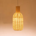 Tall bottle shaped woven rattan pendant glowing warm