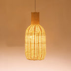 Tall bottle shaped woven rattan pendant glowing warm