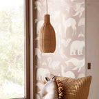 Tall bottle shaped woven rattan pendant glowing warm