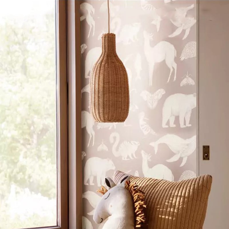 Tall bottle shaped woven rattan pendant glowing warm