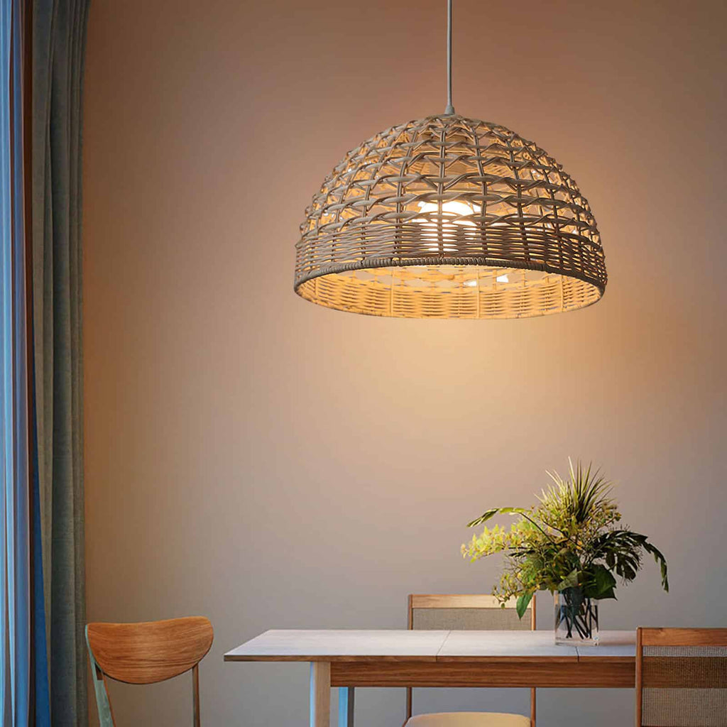 Handwoven rattan and wicker dome lamp shade hung over a table